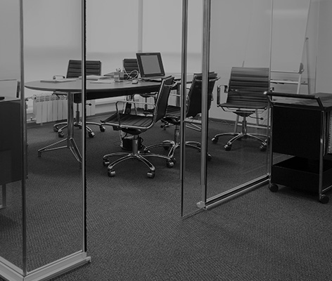 Gray textile chairs with brown wooden legs stand in a straight l